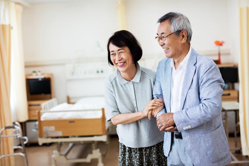 Man and woman with arms linked at doctor's office