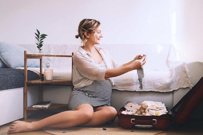 Pregnant woman packing a bag