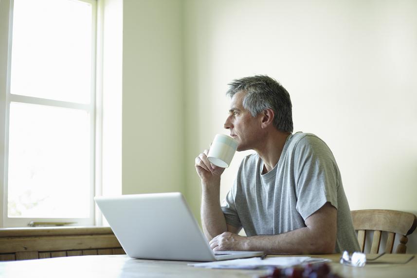 Man with laptop drinking coffee