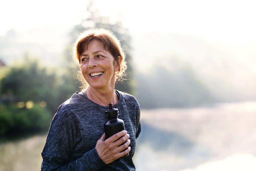 Woman outdoors with water bottle