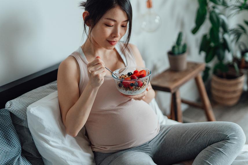 Pregnant woman eating a healthy snack