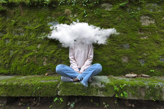 Woman whose head is covered by a cloud