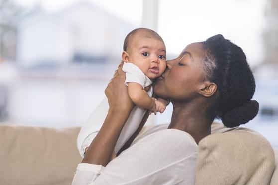 Mom kissing baby